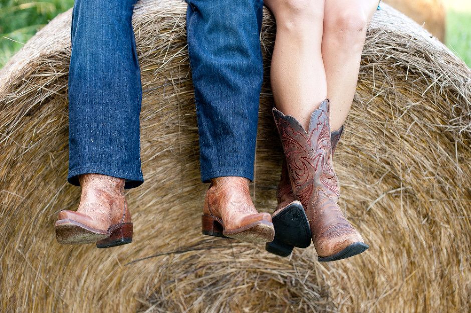 cowboy boots on beautiful couple on hay bale in Ruckersville