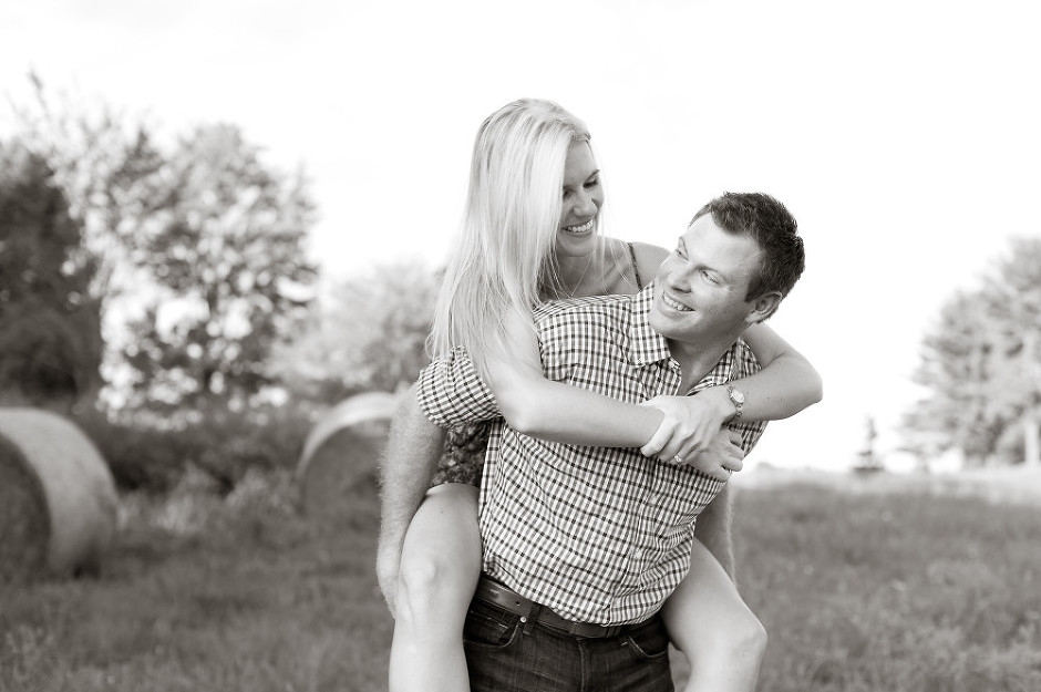 fun engagement session with fiancee on his back at the farm photo
