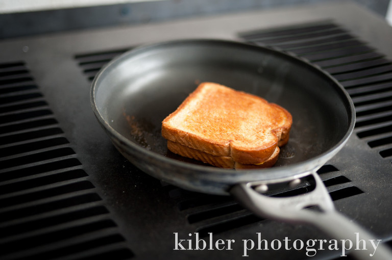 making a grilled cheese on a wood stove