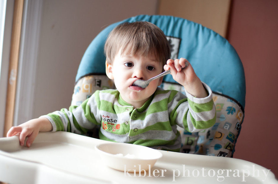 son eating snow cream in our kitchen