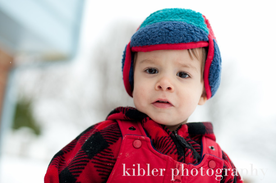 cutest boy in his snow hat out in the snow