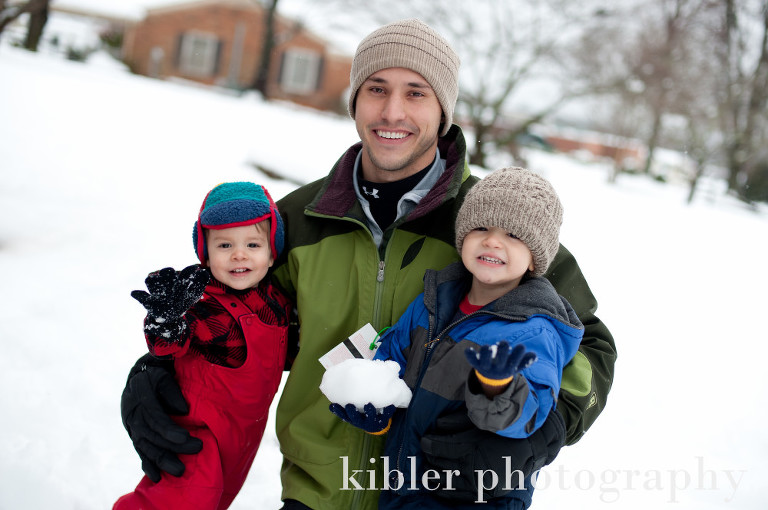 father and his sons in the snow photo