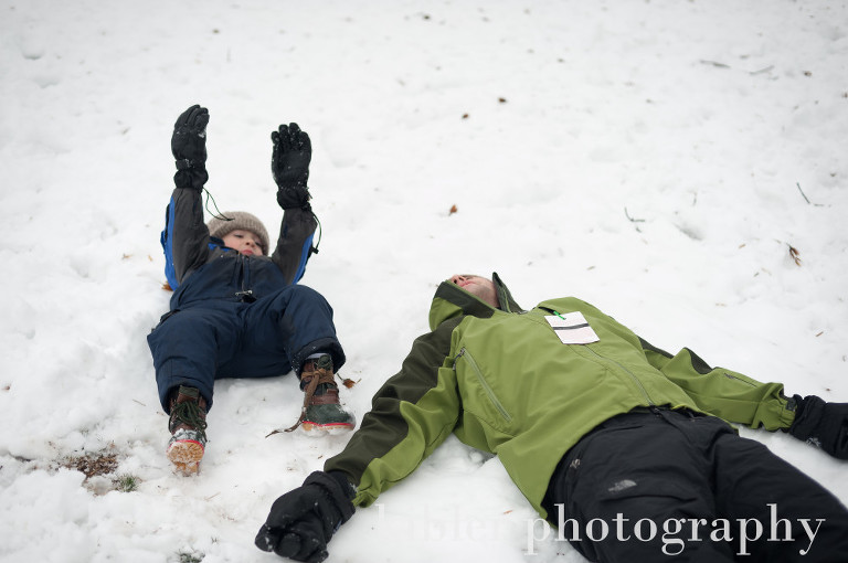 family making snow angels photo