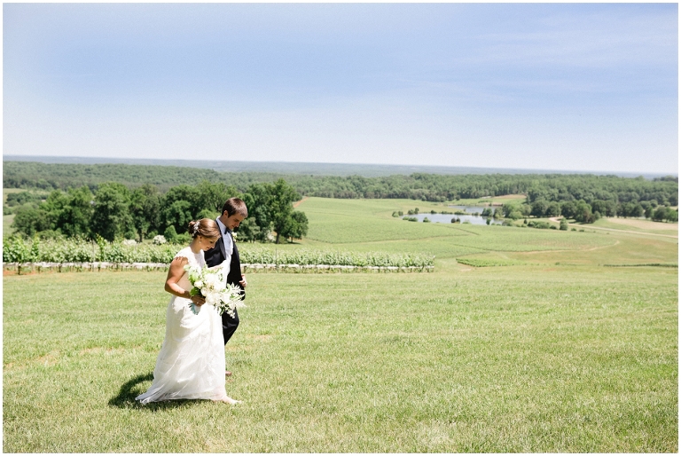 bride and groom walking together with amazing mountain views behind them at Trump Winery