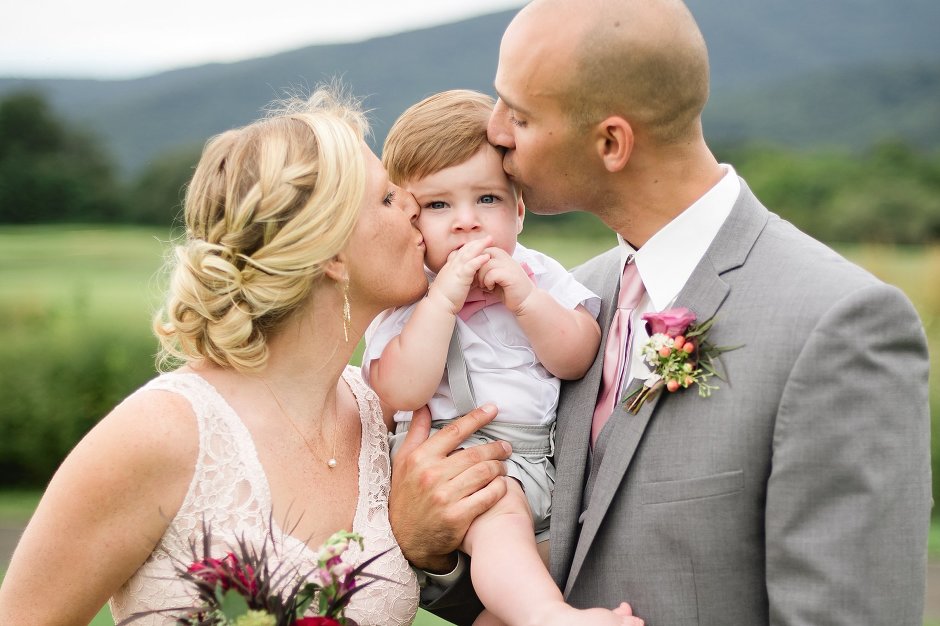 adorable ring bearer with his parents
