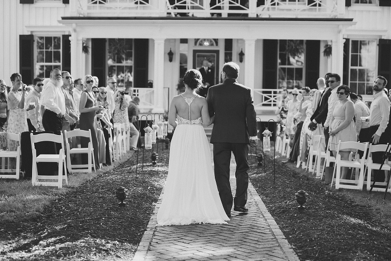historic home front porch wedding with father walking daughter down the aisle 
