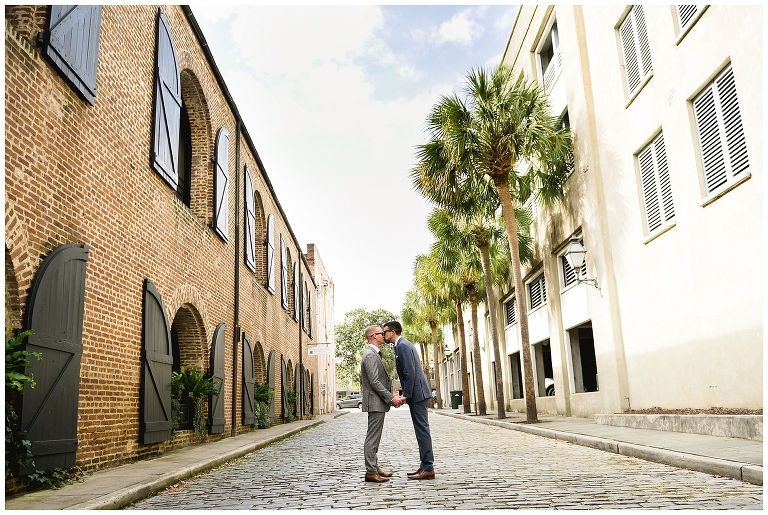 grooms kissing in Charleston Street 