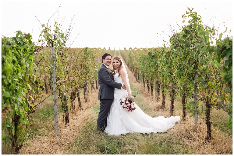 couple in the vines at wedding at Trump Winery