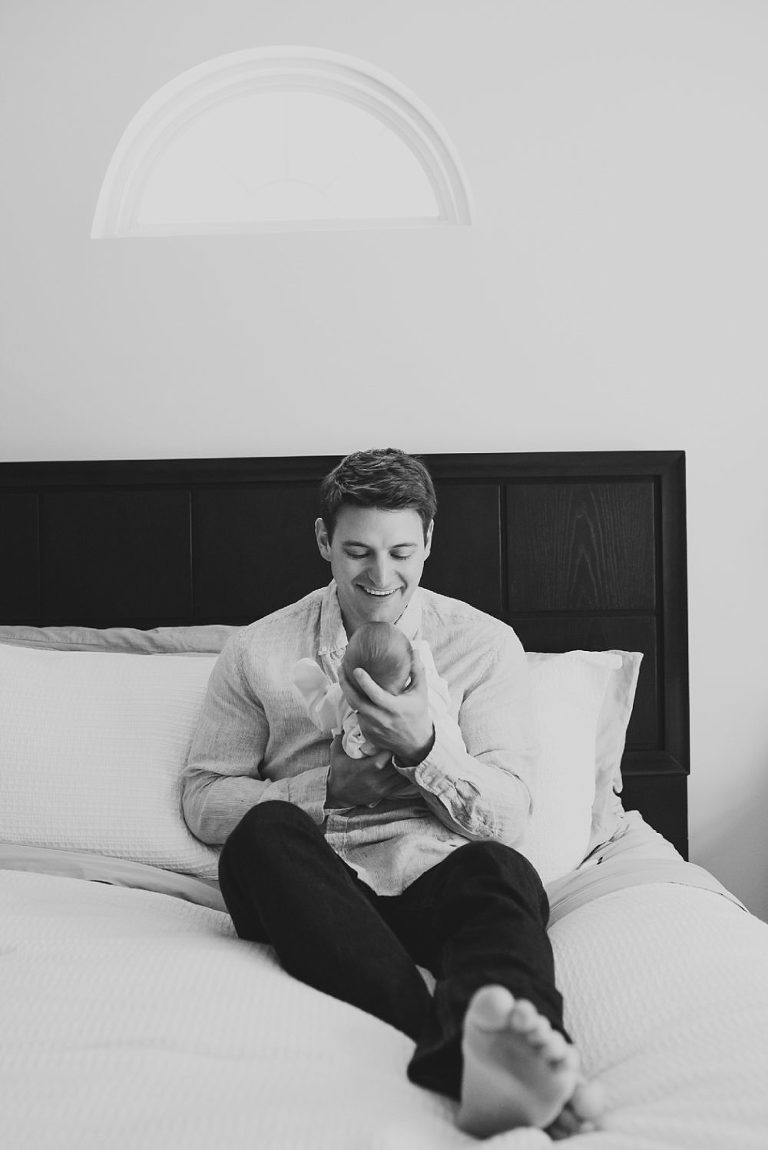 Black and white portrait of new father hold baby by Charlottesville newborn photographer