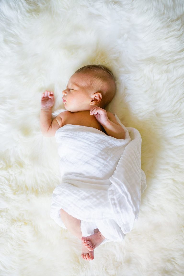 baby on soft white furry blanket