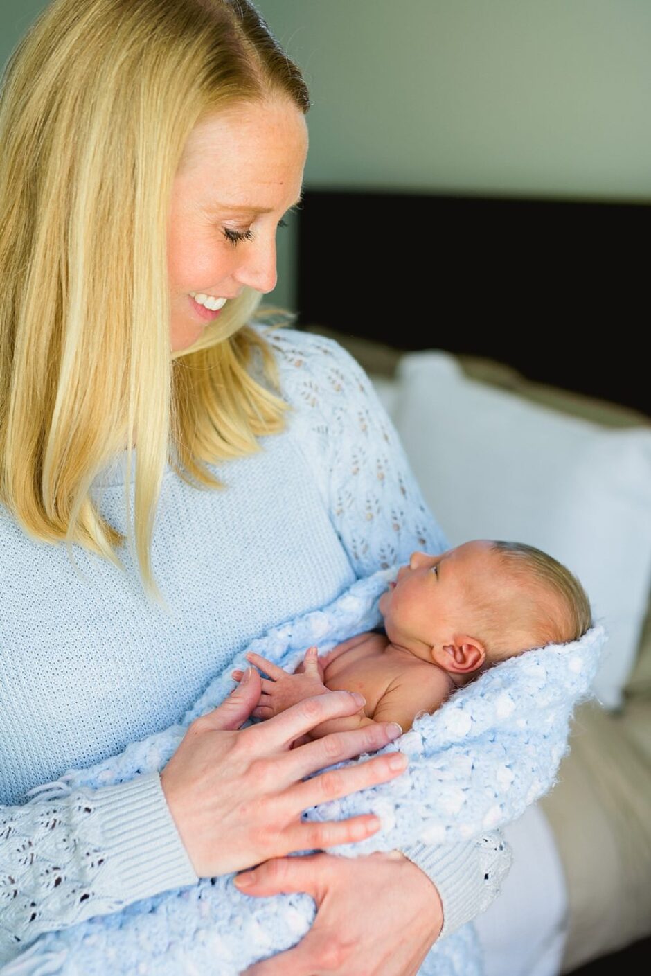 new mom holding sweet baby boy in Virginia newborn photography session