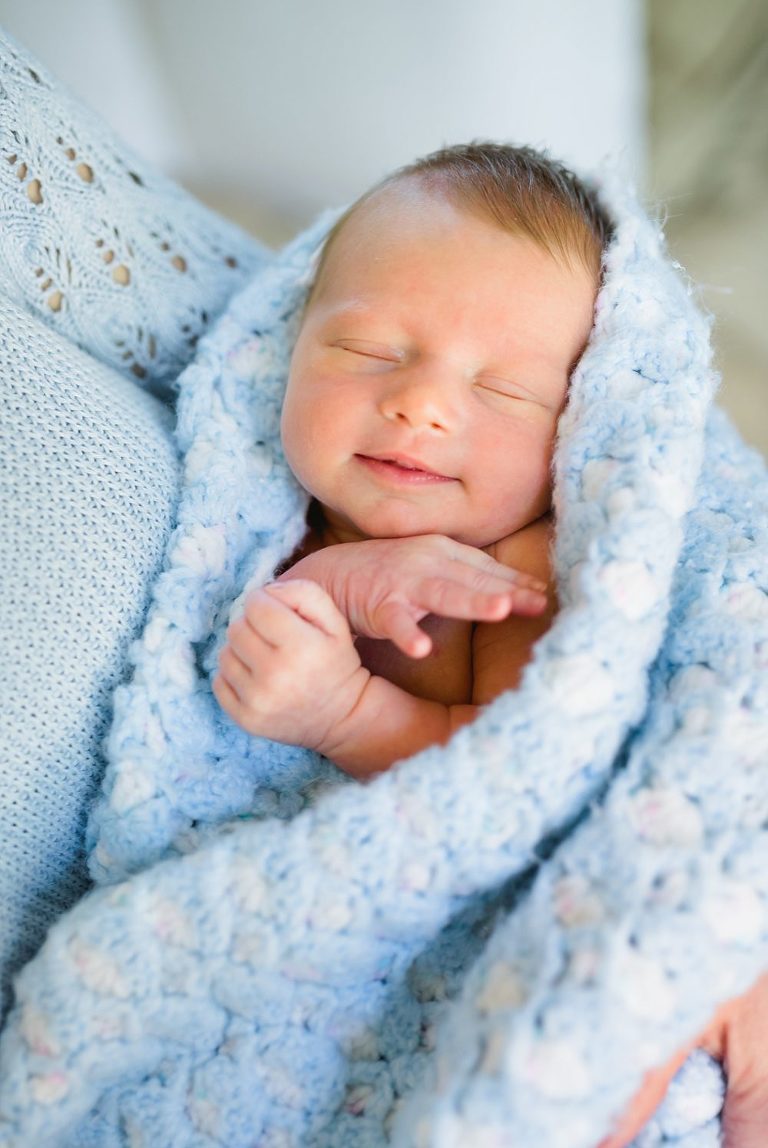 adorable baby wrapped in blue blanket by Charlottesville Virginia newborn photographer