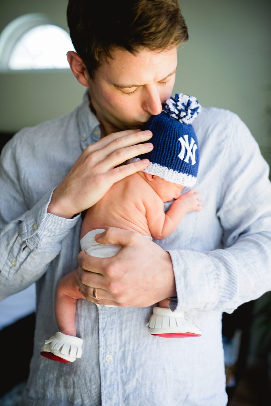 baby dressed in new yankees hat