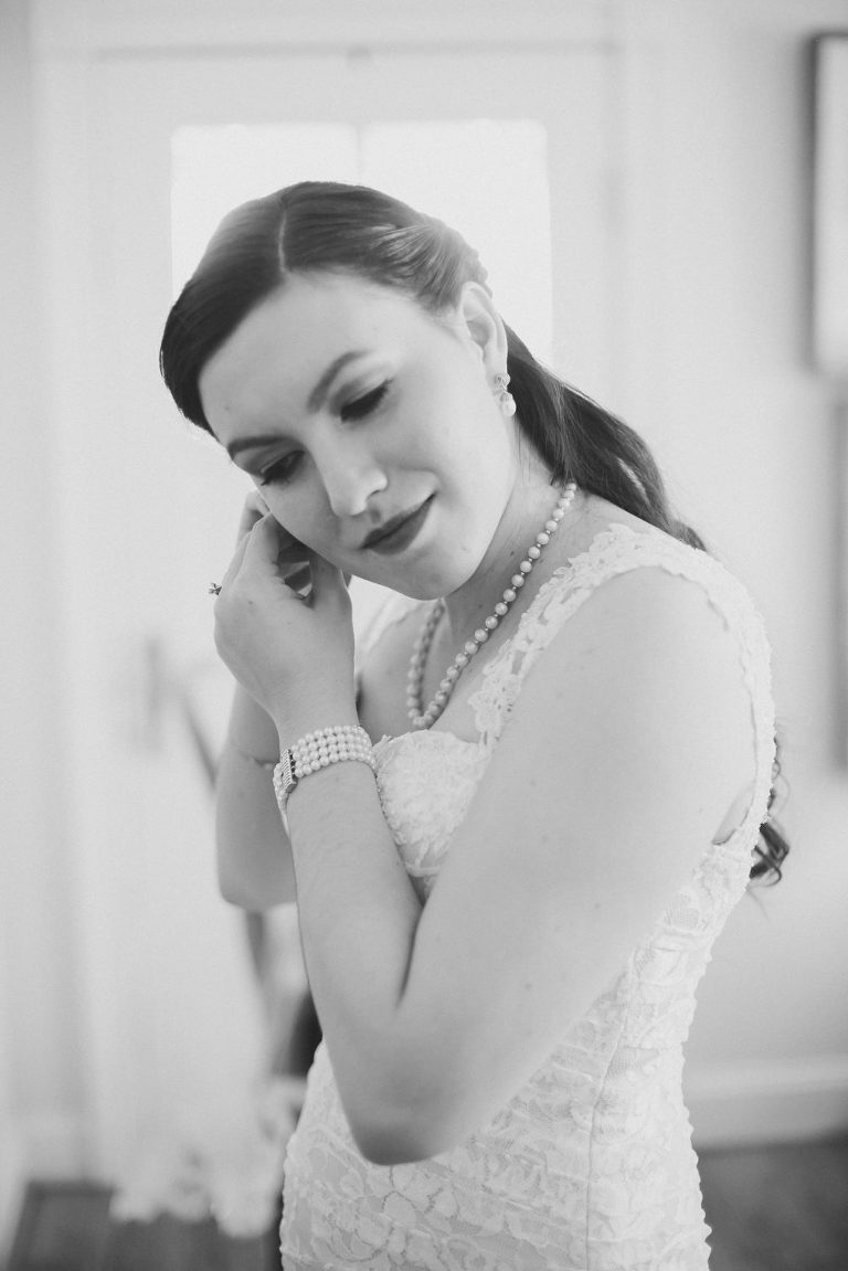 Bride putting her earrings in