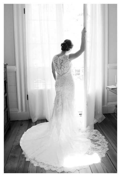 black and white portrait of bride in the doorway at Guildford Farm