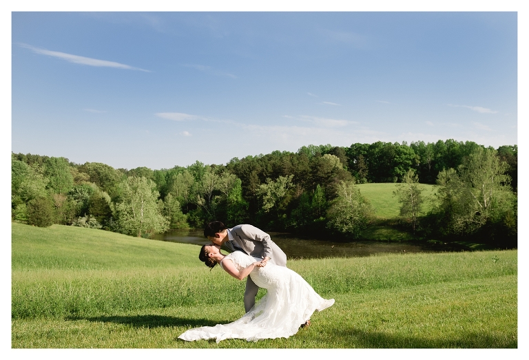 bridge and groom dip with pond backdrop at Central Virginia farm wedding venue