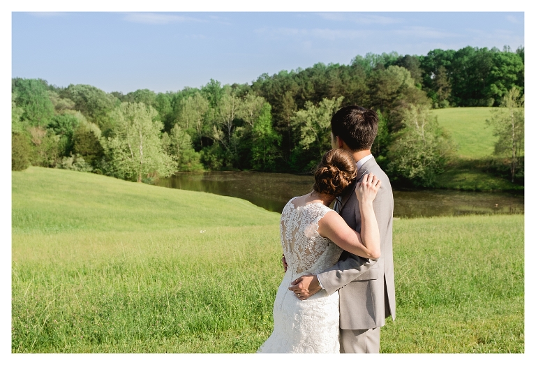 bride and groom looking out at the mountains and pond at their wedding at Guildford Farm in Ruckersville, Va