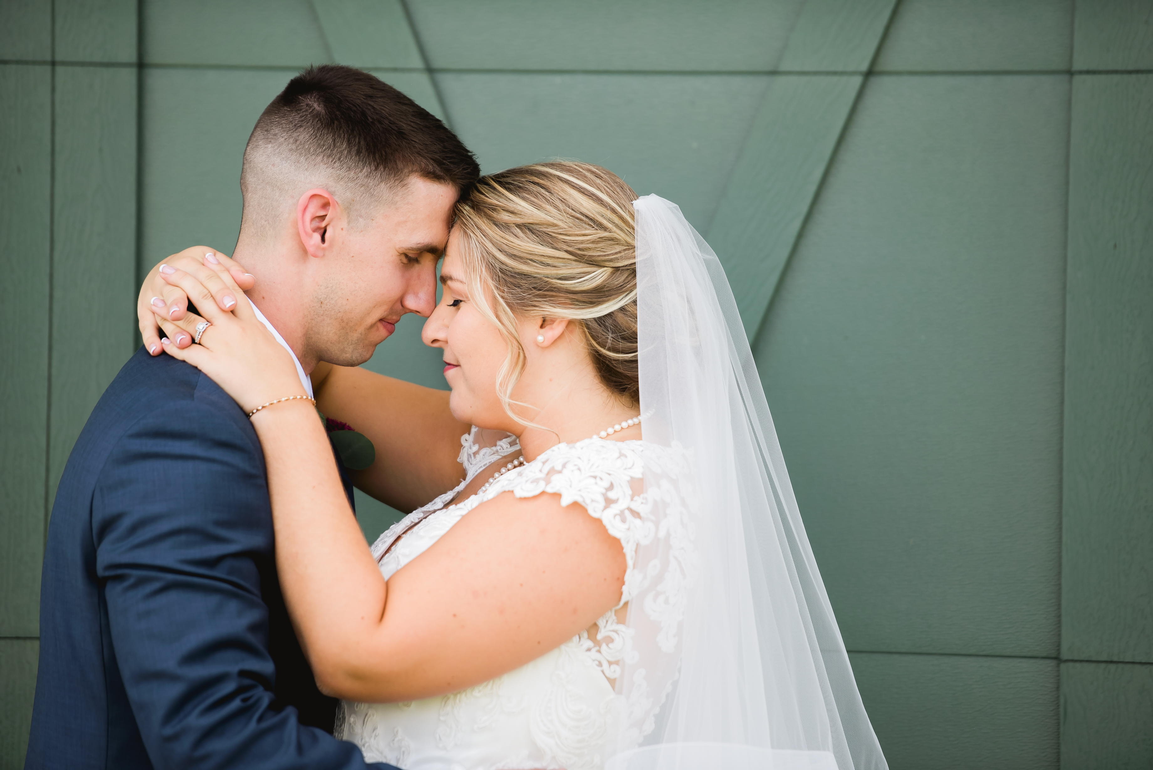 Bride and groom in front of barn doors at the barn at edgewood