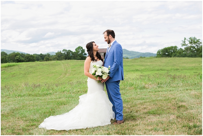 Early Mountain Vineyard Wedding with couple in front of barn