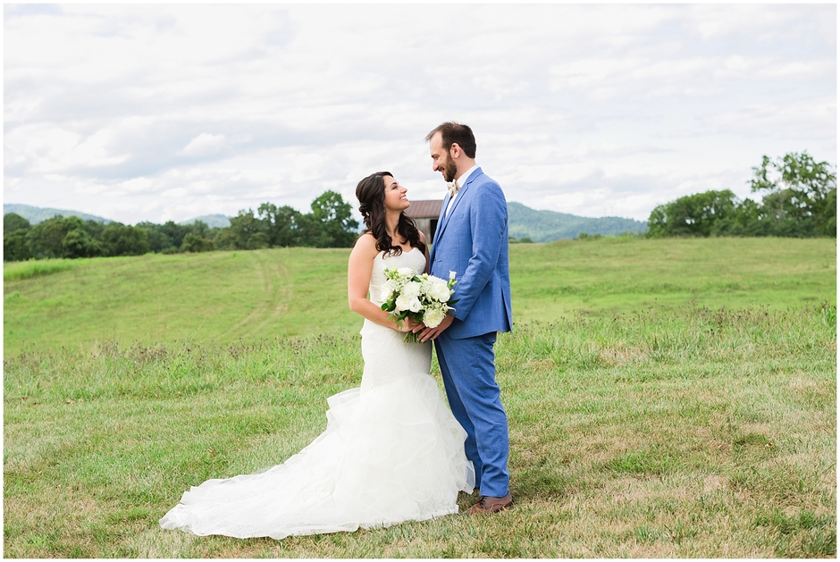 Early Mountain Vineyard Wedding with couple in front of barn