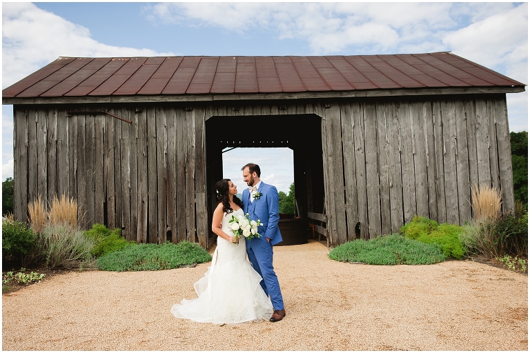 Couple in front of Early Mountain Vineyard Wedding barn 