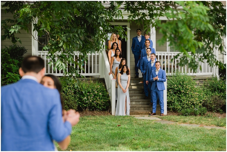 wedding party watching bride and groom first look moment at Early Mountain Vineyard cottage